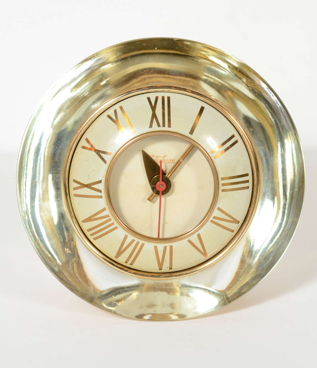 This gorgeous clock features a three dimensional case of hand blown glass incased in gold mercury glass. The face of the clock is white enamel with gilt fittings and is made by Telechron co. It works perfectly and would be a stunning addition to any