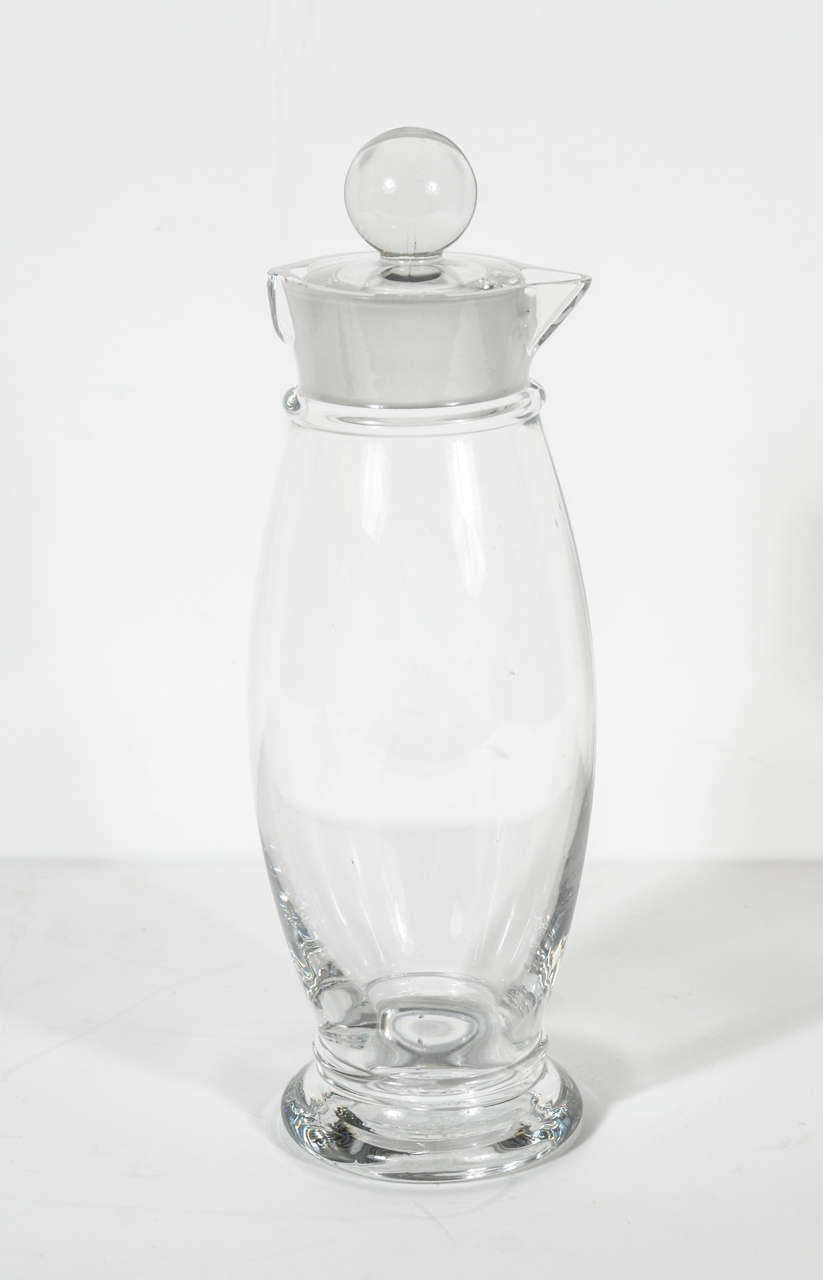 This stunning Art Deco crystal glass cocktail shaker features a streamline penguin-like design and is fitted with a lid adorned with a crystal ball finial.A great bar accessory and decorative object.