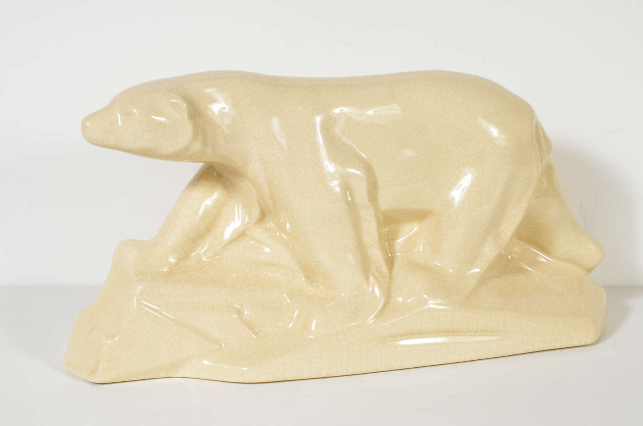 This Art Deco ceramic sculpture, depicting a polar bear strolling along a chunk of glacier ice, has a lovely craqueleur glaze. Created by the renowned fine artist artist Charles Lemanceau, this work features the signature characteristics of the