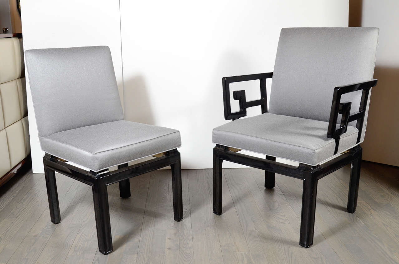 This pair of stunning occasional chairs were realized by Baker in the United States circa 1960. They feature an abstracted geometric Greek Key design that comprises the arms as well as rectangular legs all finished in lustrous black lacquer. With