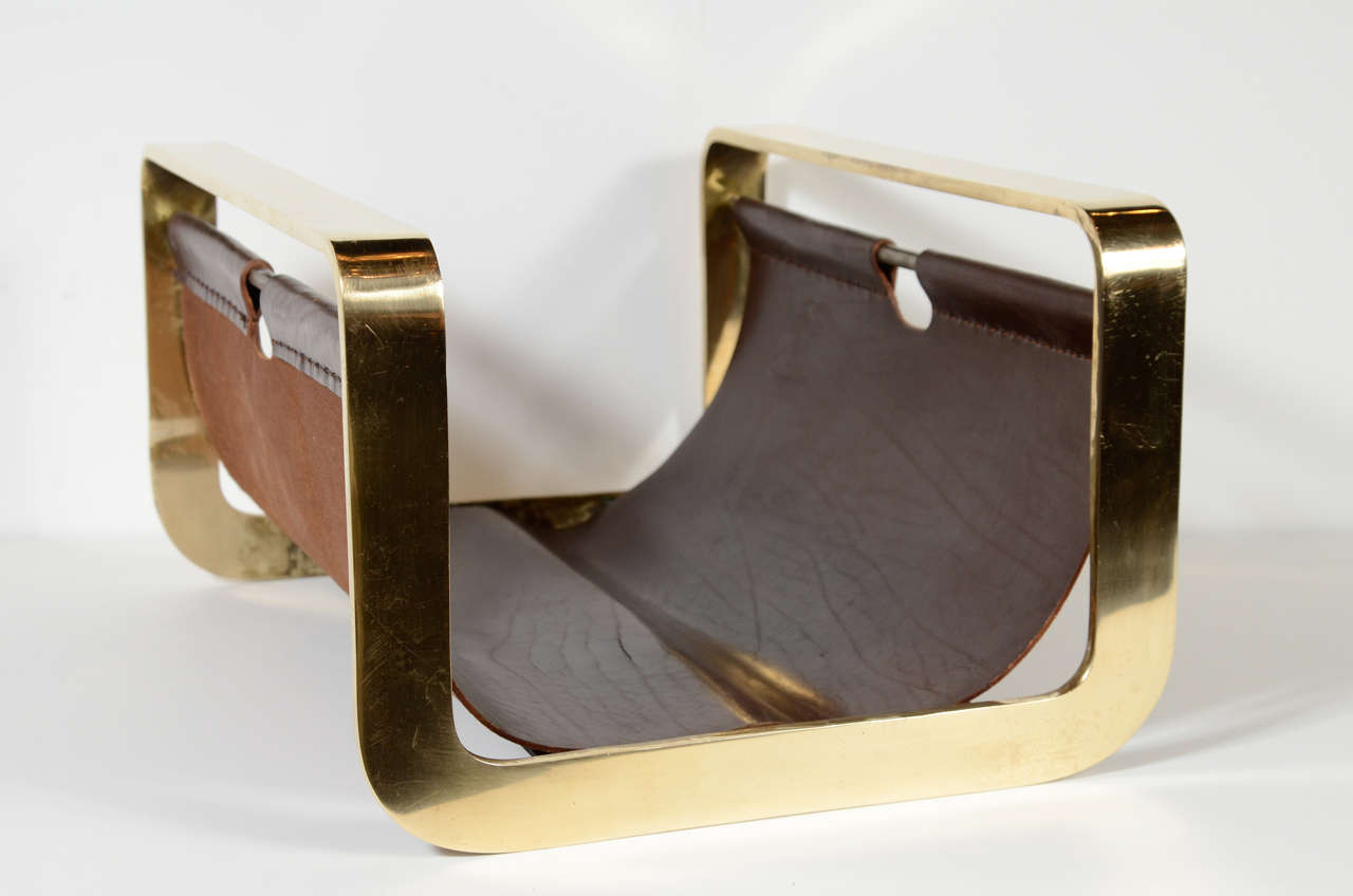 This chic  Modernist log holder has a leather sling supported by a banded brass frame.