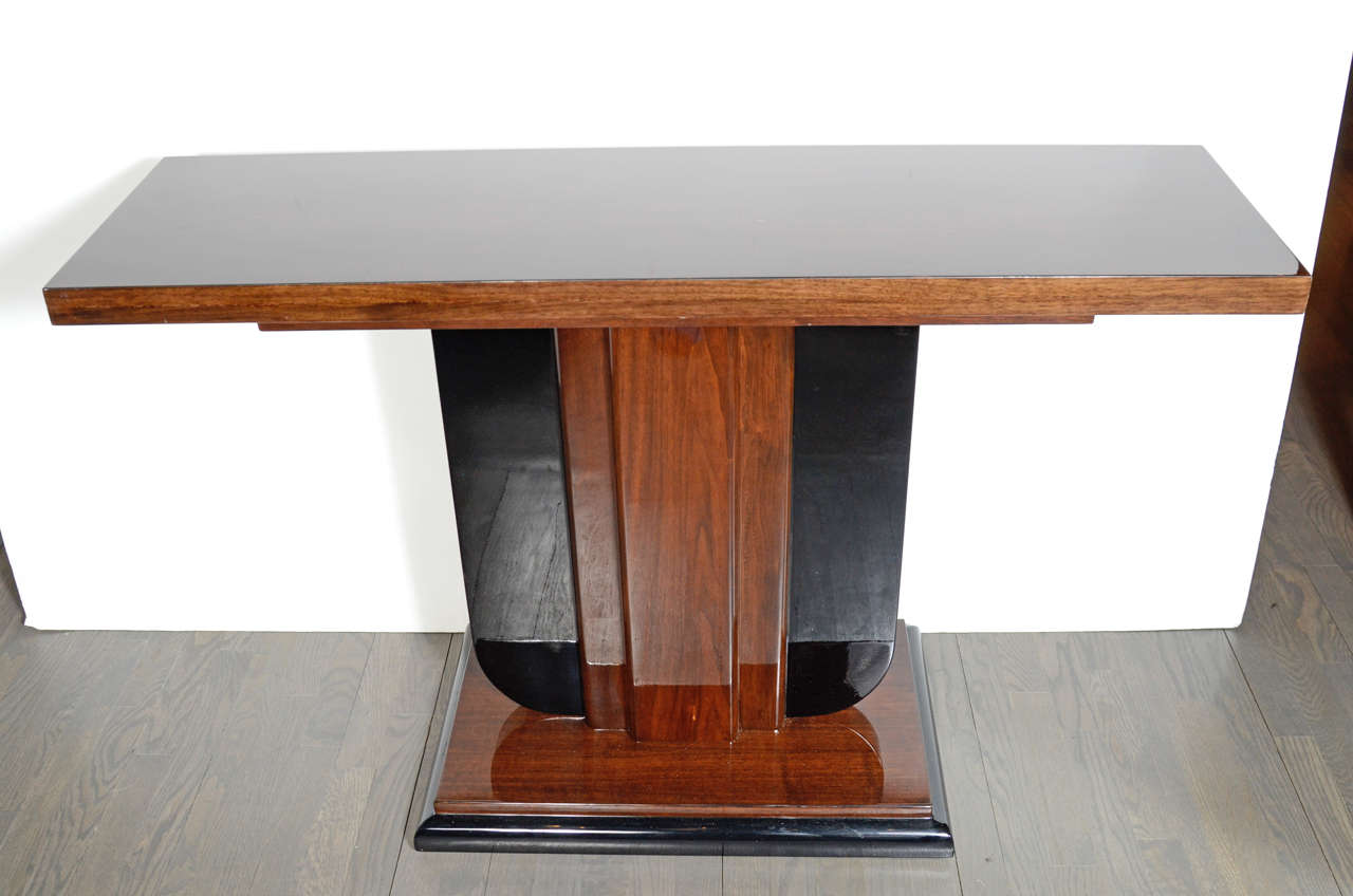 Outstanding Art Deco Skyscraper style Console features a stepped pedestal style base and top made in book matched walnut and black lacquer.