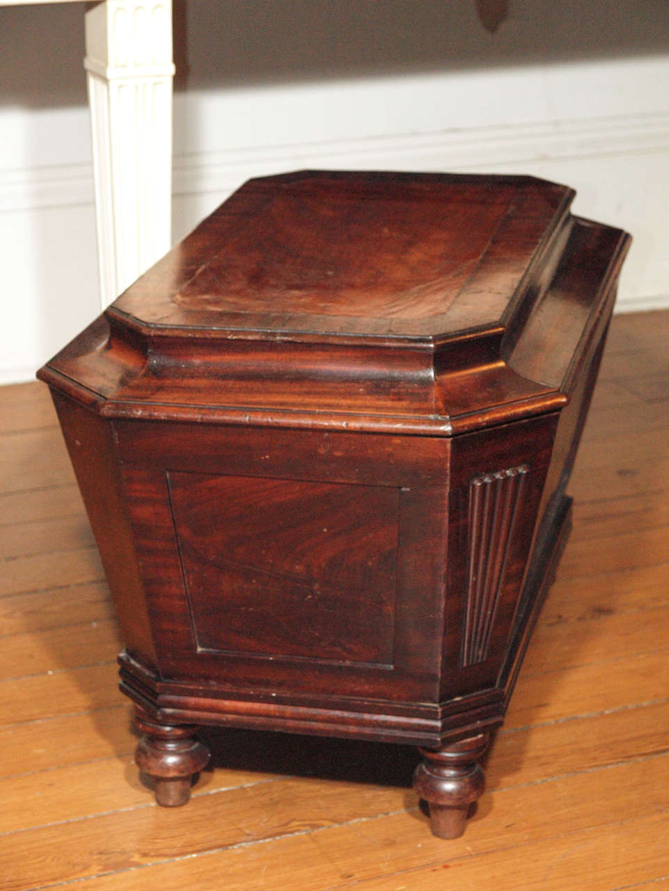 English Regency Sarcophagus form Cellarette with flat top and four turned legs. 

