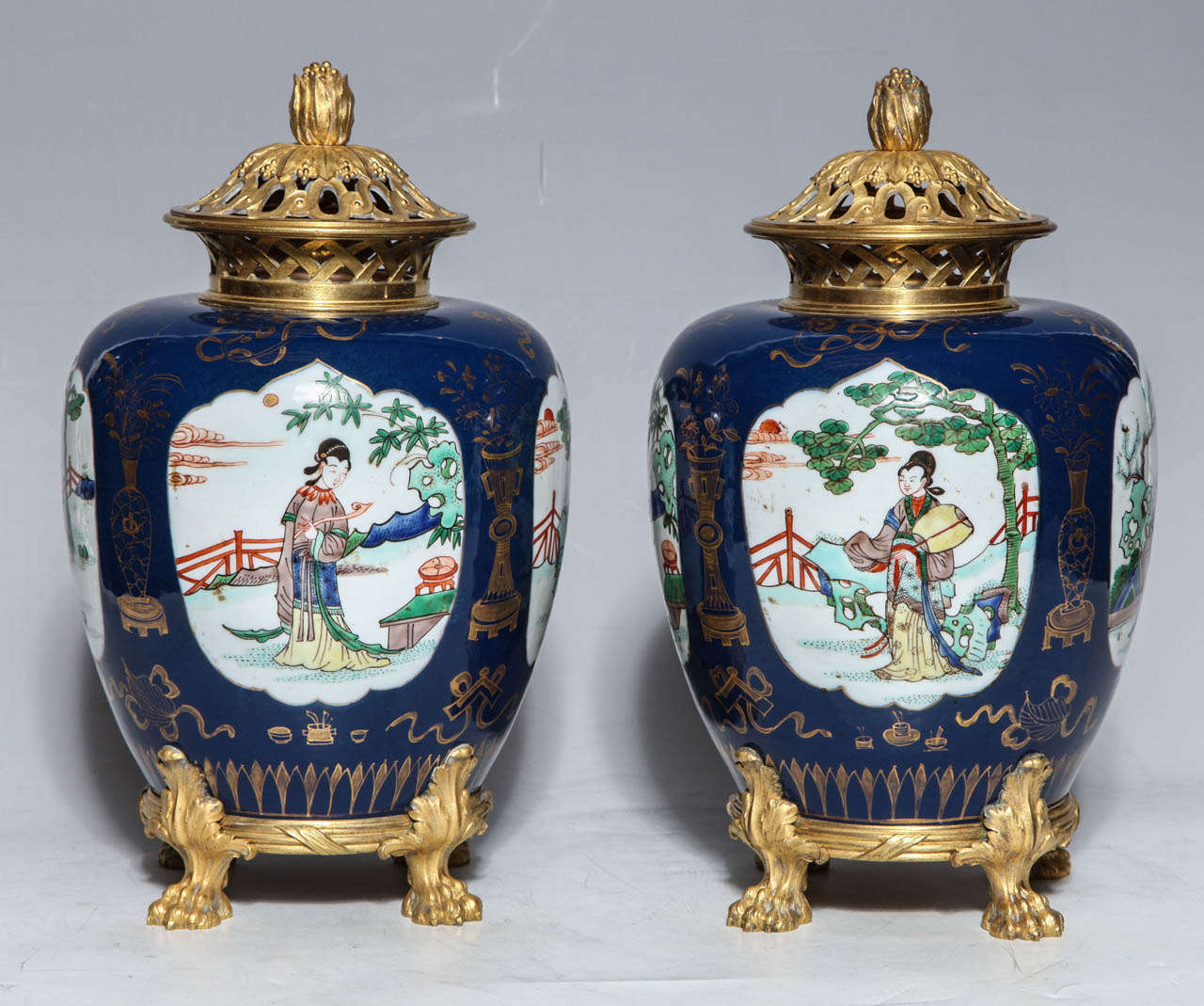 A Pair of Late 18th/Early 19th Century Mazarin Blue Chinese Porcelain Ginger Jars with Fine Quality French Gilt Bronze Mounts. The dark blue ground (named after one of France's most notorious Cardinals) is enlivened by gilt swags and festoons. The