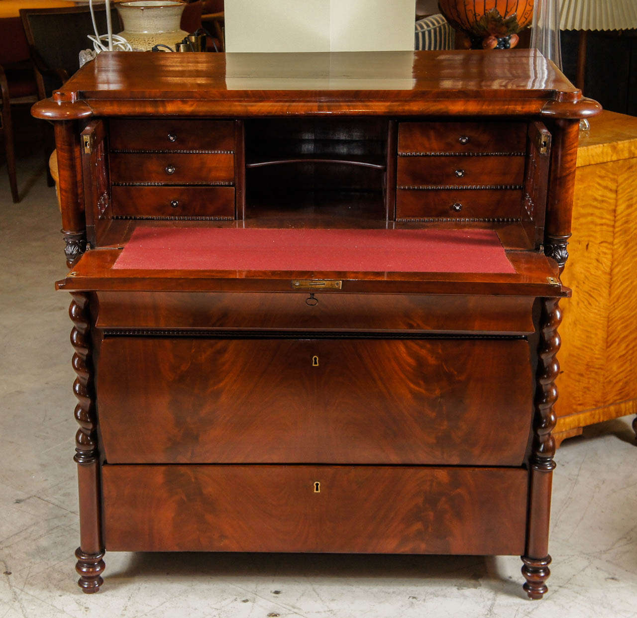 Danish 1830s-40s Butler's Desk of Flame Mahogany.  The top over a fall-front opening to reveal an interior space fitted with three small drawers on each side flanking a interior space.  The fall-front over three drawers flanked by spiral columns. 