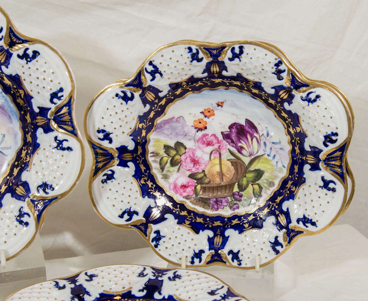 English A Set of Dishes: A Dessert Service with Cobalt Blue and a Basket of Flowers