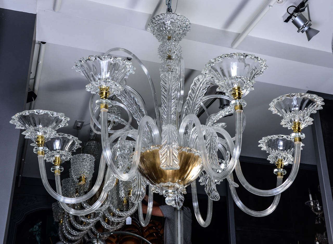 Big Murano glass chandelier, eight lights, leafs shaped and volute decorations, blown glass centerpiece, golden lower piece. Venetian style chandelier, new electrification, Italy 1960s.