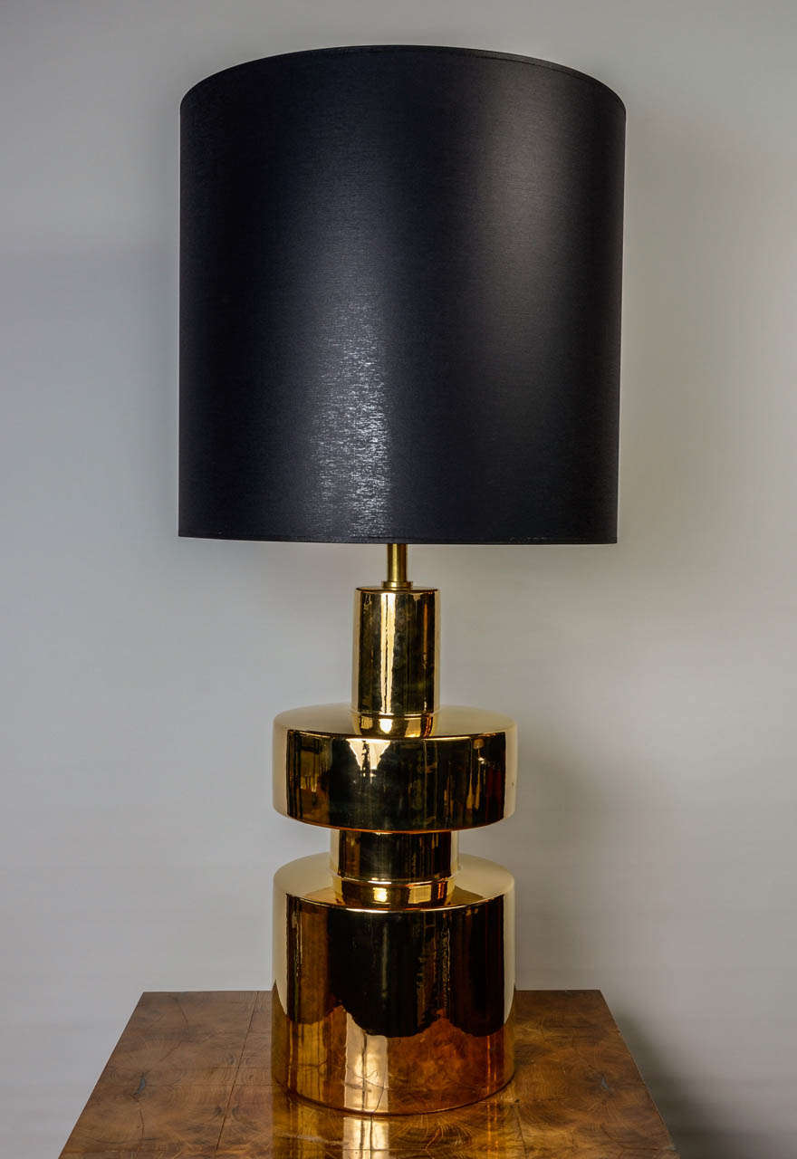 Pair of golden ceramic lamps, made in Italy in the 1980s, new shades made of black fabric and golden inside to reflect the light. New electrification and perfect condition.

Dimensions without shades:  ø30 H57          cm
                        