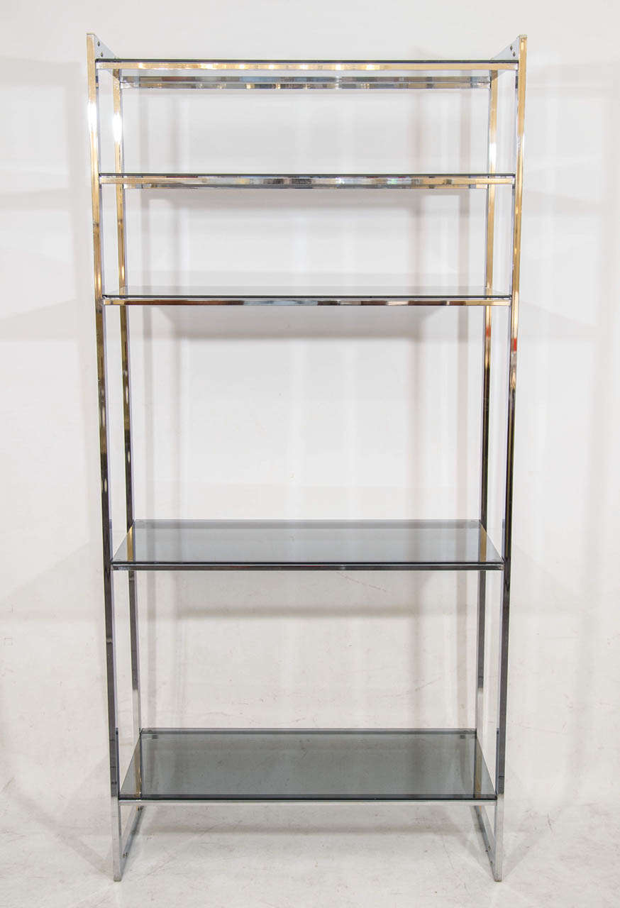 Crisply designed chrome étagère with gray glass shelves. Please contact for location.
