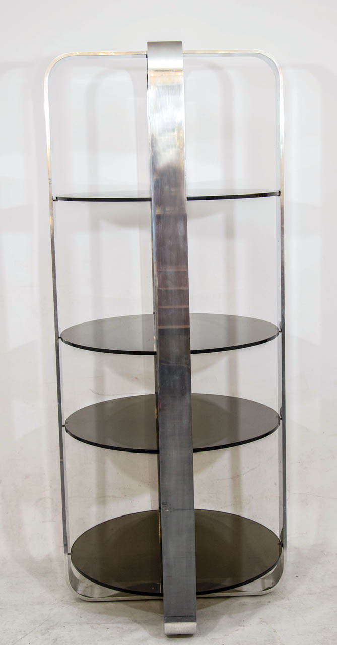 Remarkable circular tower etagere with sculpture polished aluminum supports and dark smoke tinted glass. Substantial and heavy; nicely done. Please contact for location.