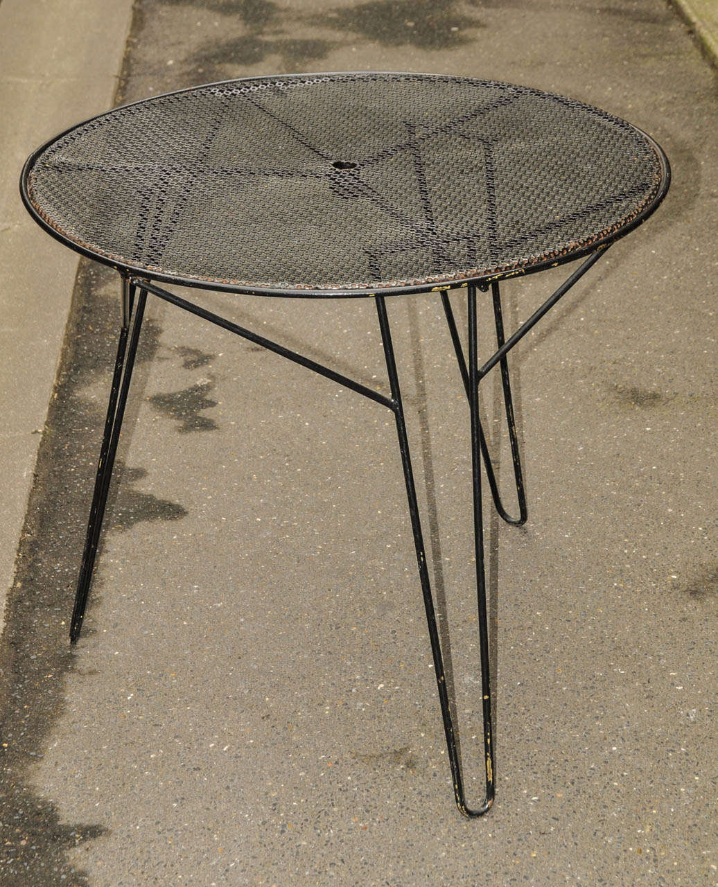 1980's garden table. Original legs and non original top. Black lacquered metal. Lost paint. Normal wear consistent with age and use.