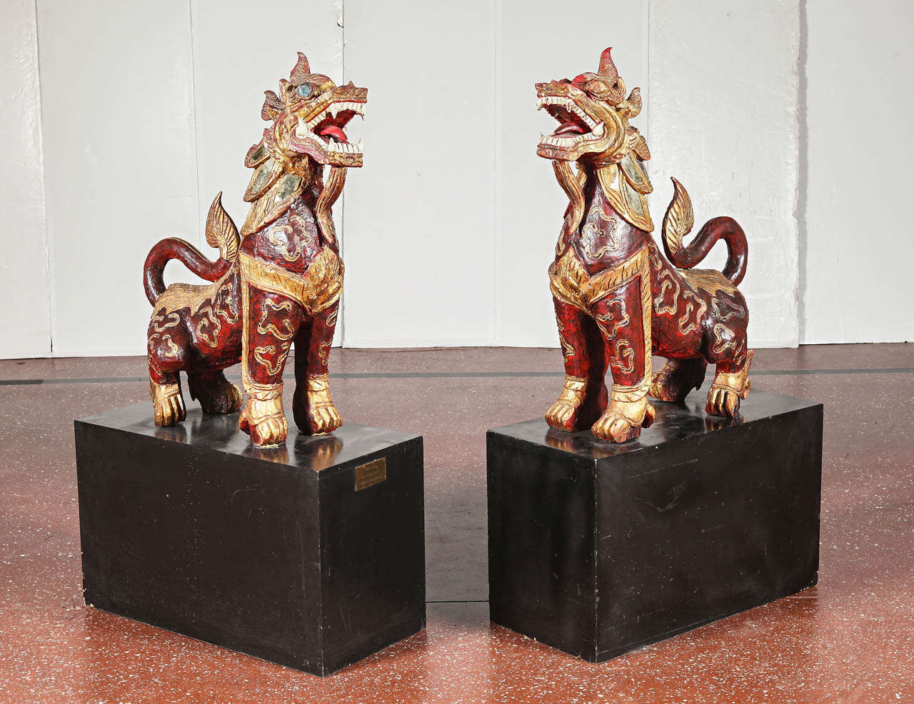 Pair of carved red lacquer painted & giltwood temple lions, c. 1900.