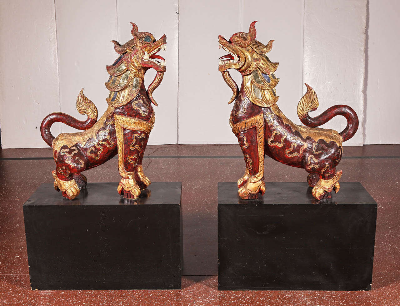 Pair of Carved Red Lacquer Painted & Giltwood Temple Lions. c. 1900 In Good Condition In Dallas, TX