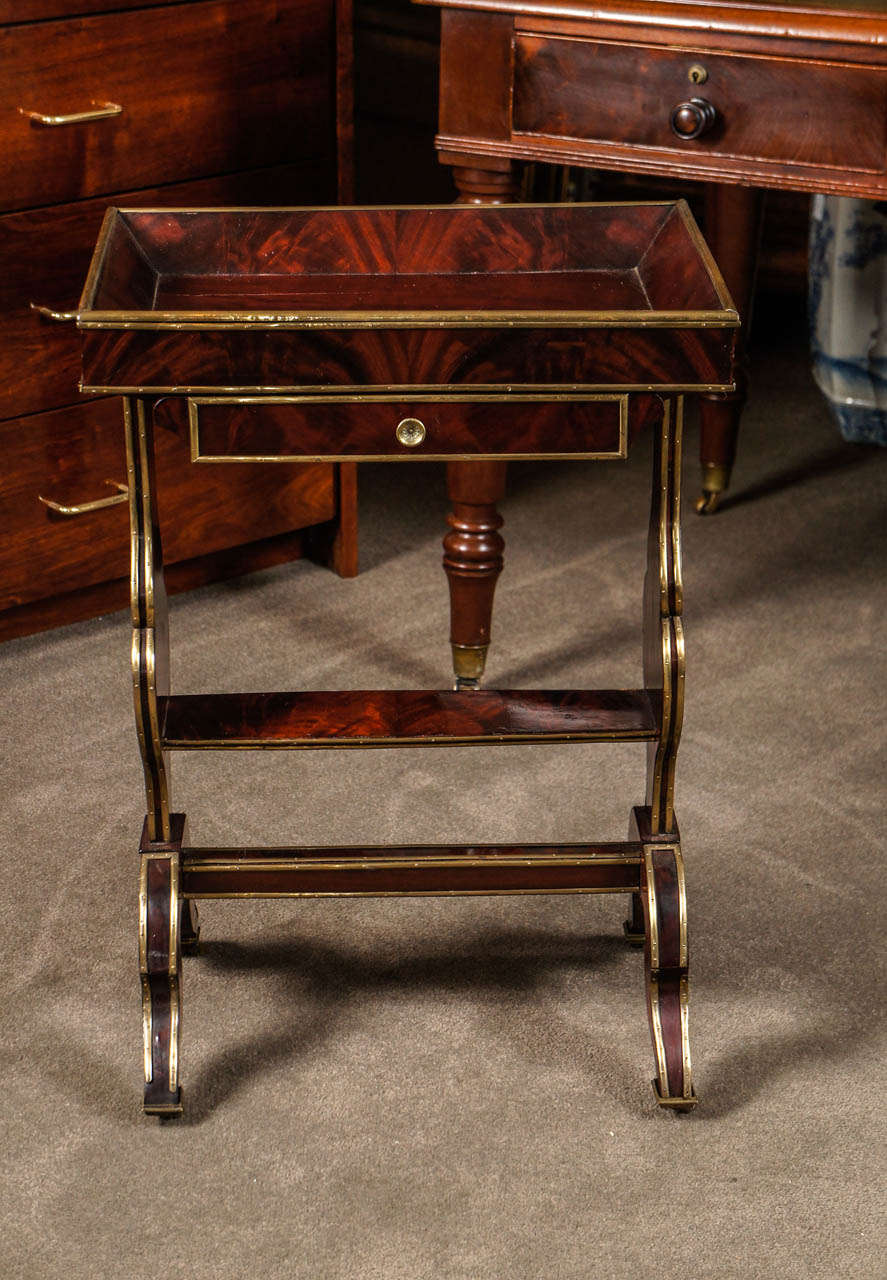 Russian side table with single drawers and brass details.