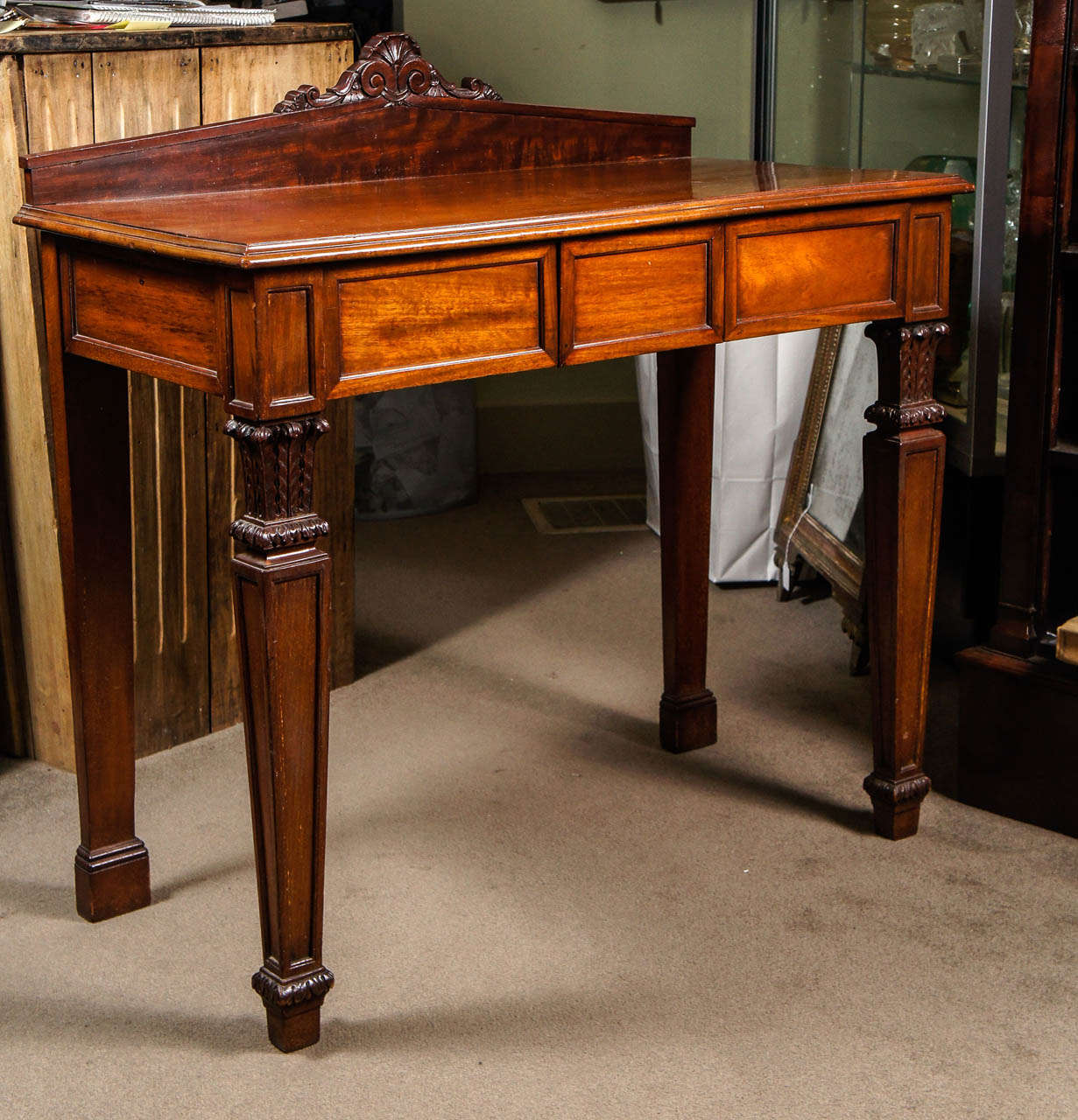 William IV mahogany console with three hidden drawers and fine carvings.