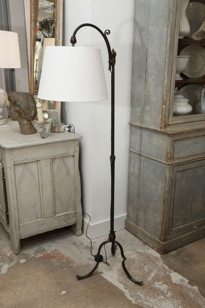 Vintage iron goose-neck French floor lamp with remnants of gilt and an adjustable angle linen shade.