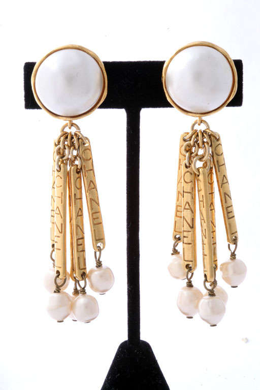Chanel earrings with pearls with gold bar's with CHANEL logo.