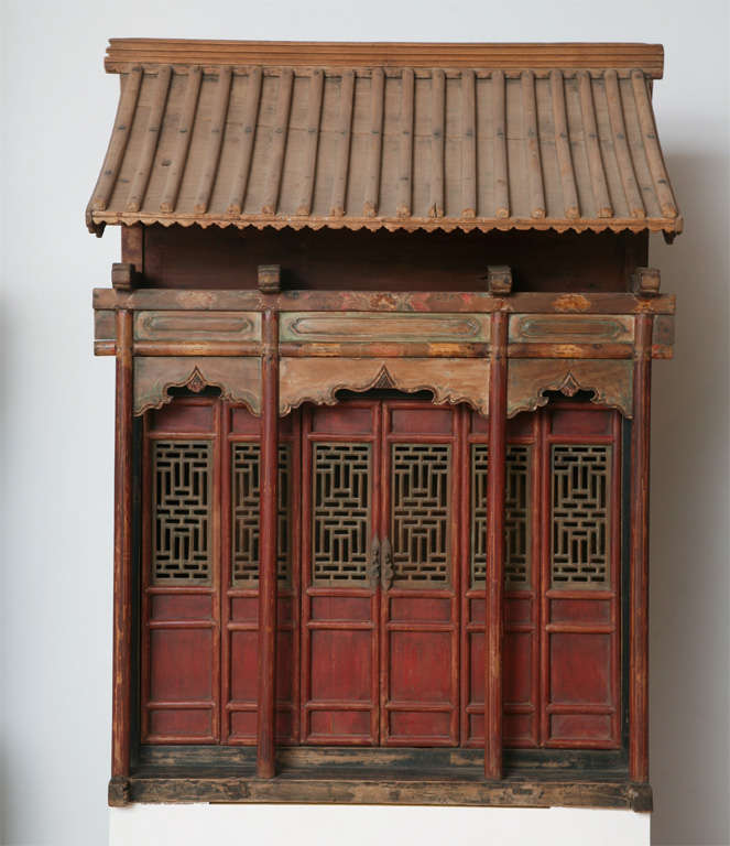 a very rare example of an ancestral shrine which once contained name plaques of a family clan in Northern China, Shanxi province.<br />
Retaining its orign. patina and traces of pigment,this remarkable shrine is a replica of the clan's estate.