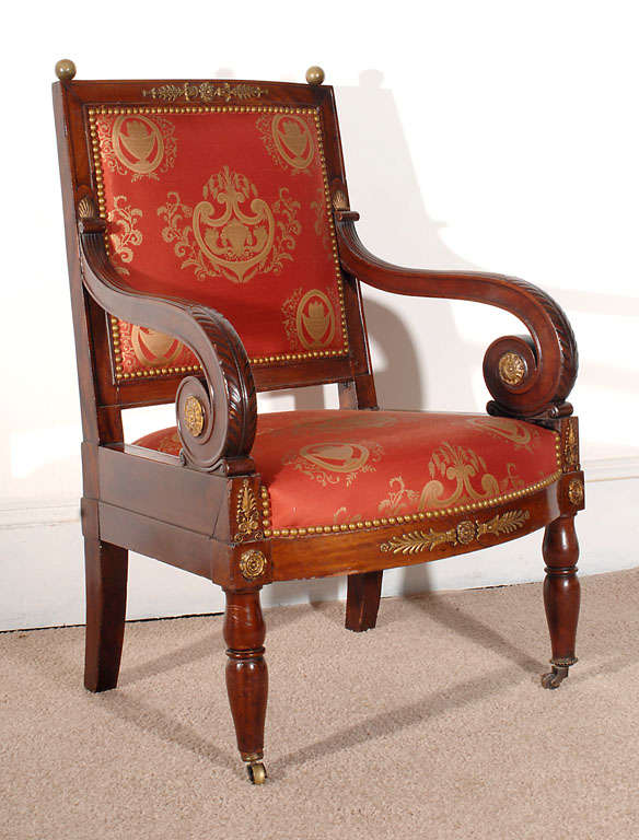 This chair is an excellent example of Napoleonic design. All of its ormolu mounts are original.