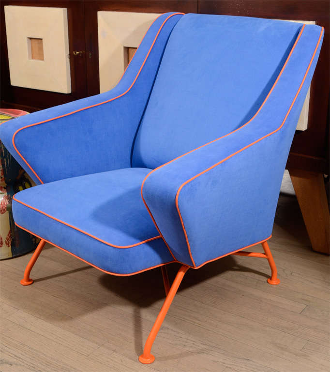 Pair of armchairs upholstered in blue canvas with orange piping with enameled legs.