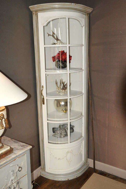 A pair of 19th century French Louis Philippe corner cupboards with curved glass doors.