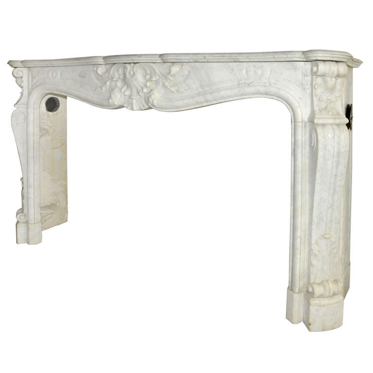 An early 19th century French Rococo Carrara marble fireplace / mantel piece