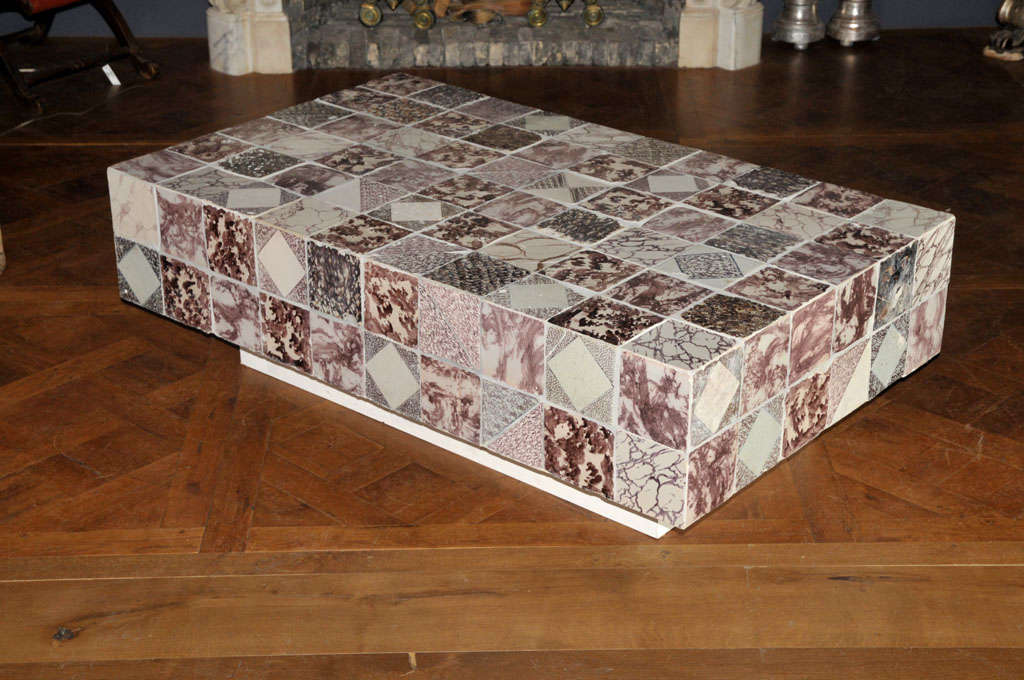 A coffee table made of 124 18th century Dutch tiles with tortoiseshell and marble impressions.