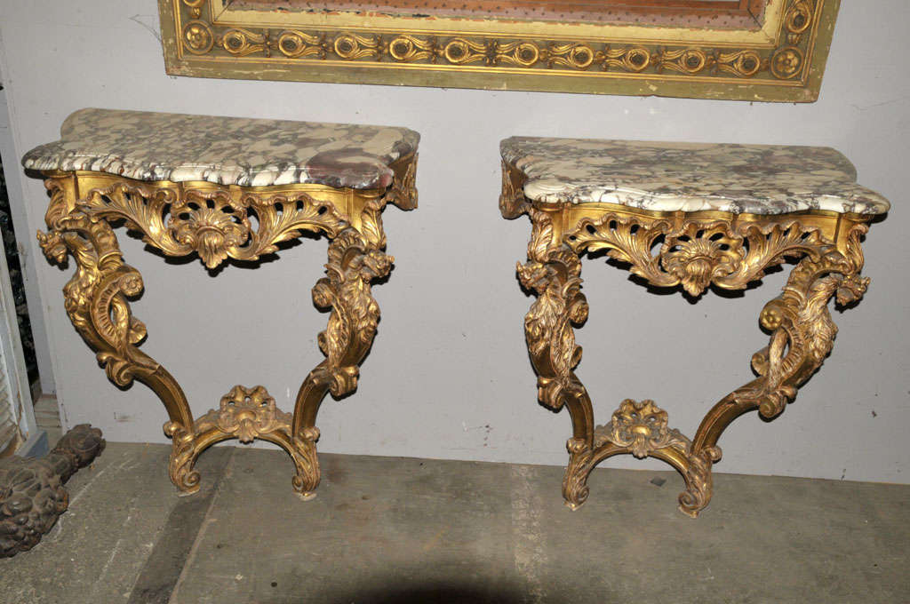 A pair of 19th century French Rococo giltwood console tables