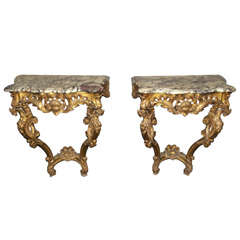 A pair of 19th century French Rococo giltwood console tables