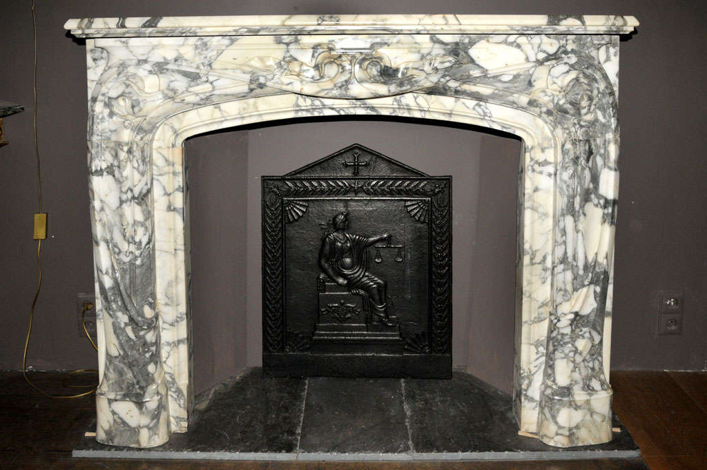 Art noveau carved brèche violette marble chimneypiece.