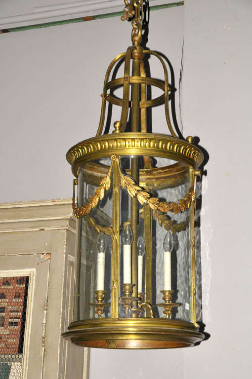 A large 19th century French gilt bronze electrified cylindrical hall lantern in Neoclassical style, its bronze parts heavily executed.