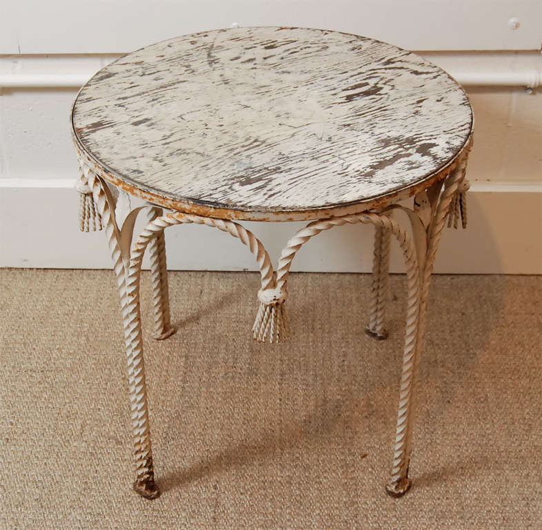 Here is a charming side table with a distressed painted top and iron base.