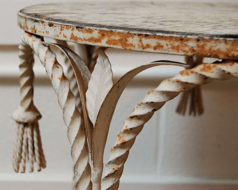 A Painted Iron Side Table with Tassels 1