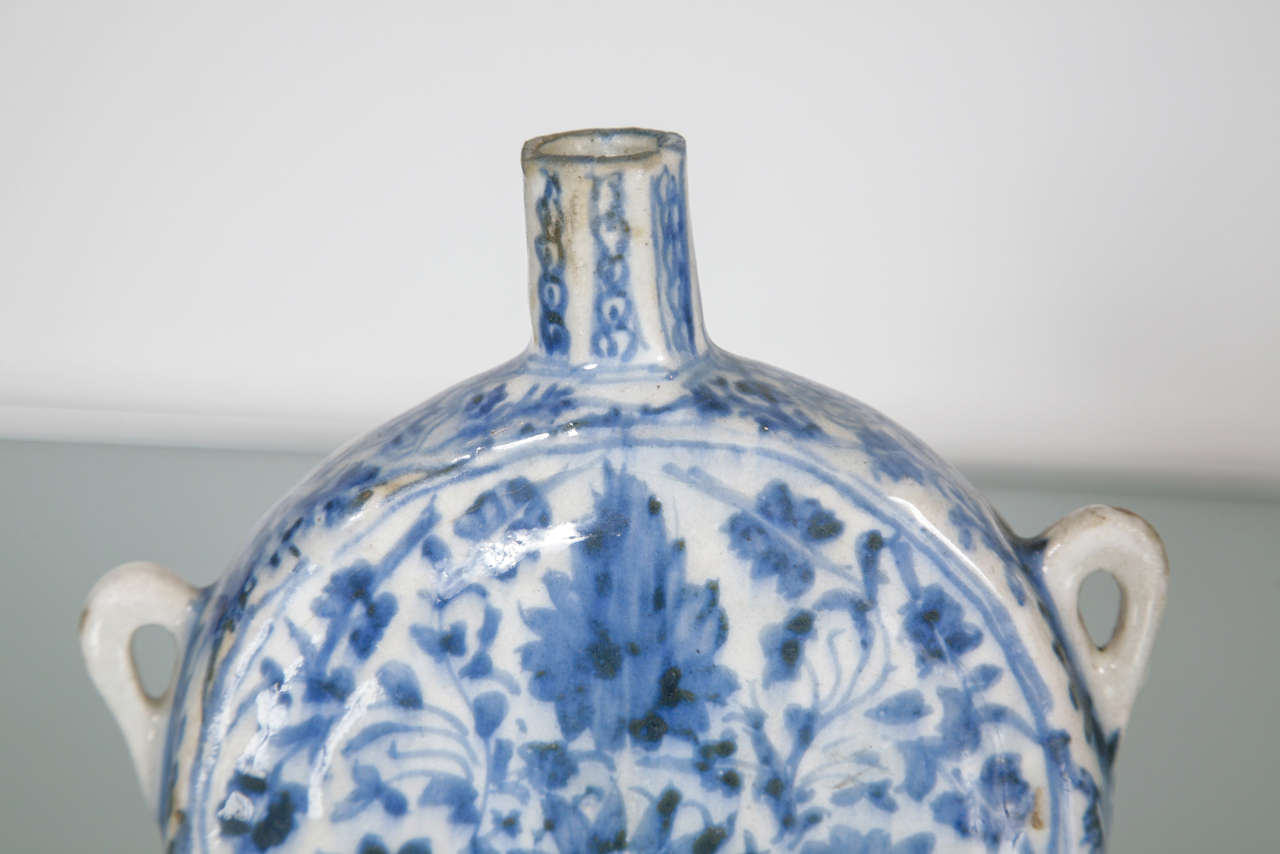 Safavid blue and white pilgrim flask with loop handles and elongated neck.