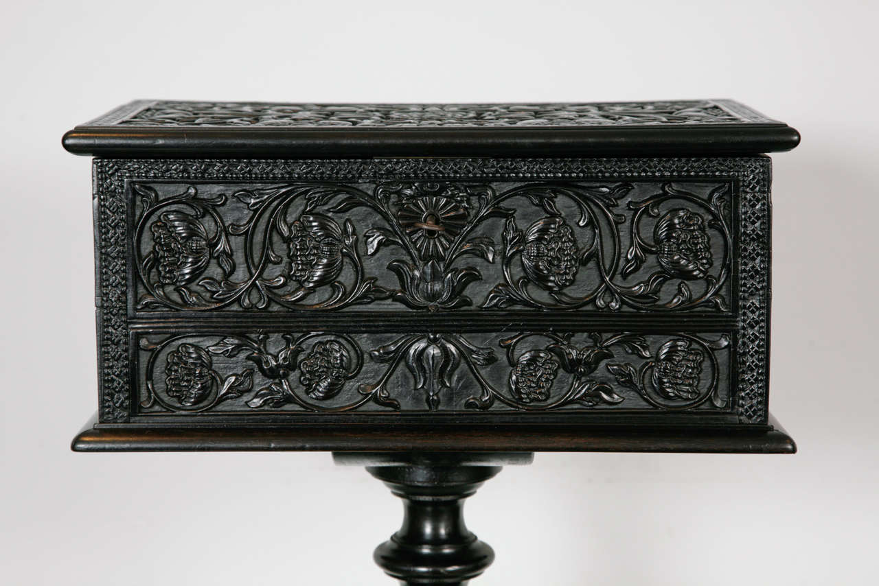 Intricately carved teapoy with floral decoration on a four stemed leg, Galle district, Sri Lanka