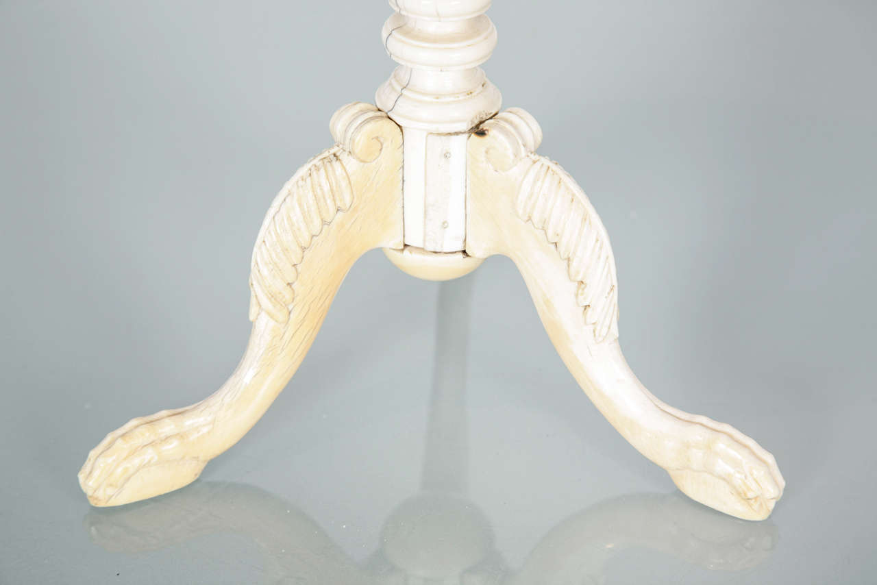 Solid turned and carved ivory tripod table known as teapoy, the form derived directly from European candlestands, used for candles and also acted as a hookah stand. 

A similar example is in the Victoria & Albert Museum.

