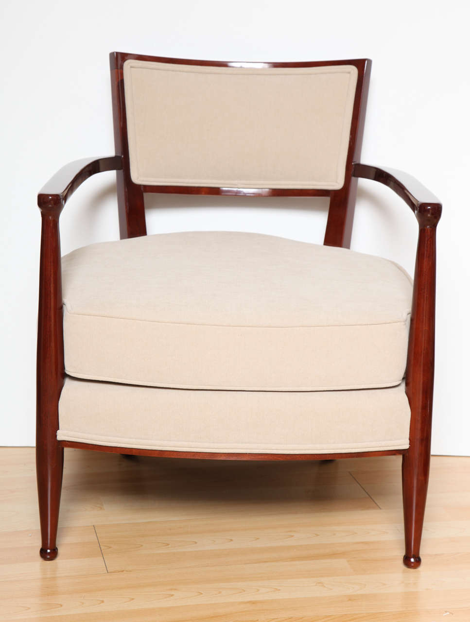 A pair of Art Deco chairs made of solid maple and stained mahogany. Newly upholstered in a cream cotton fabric.