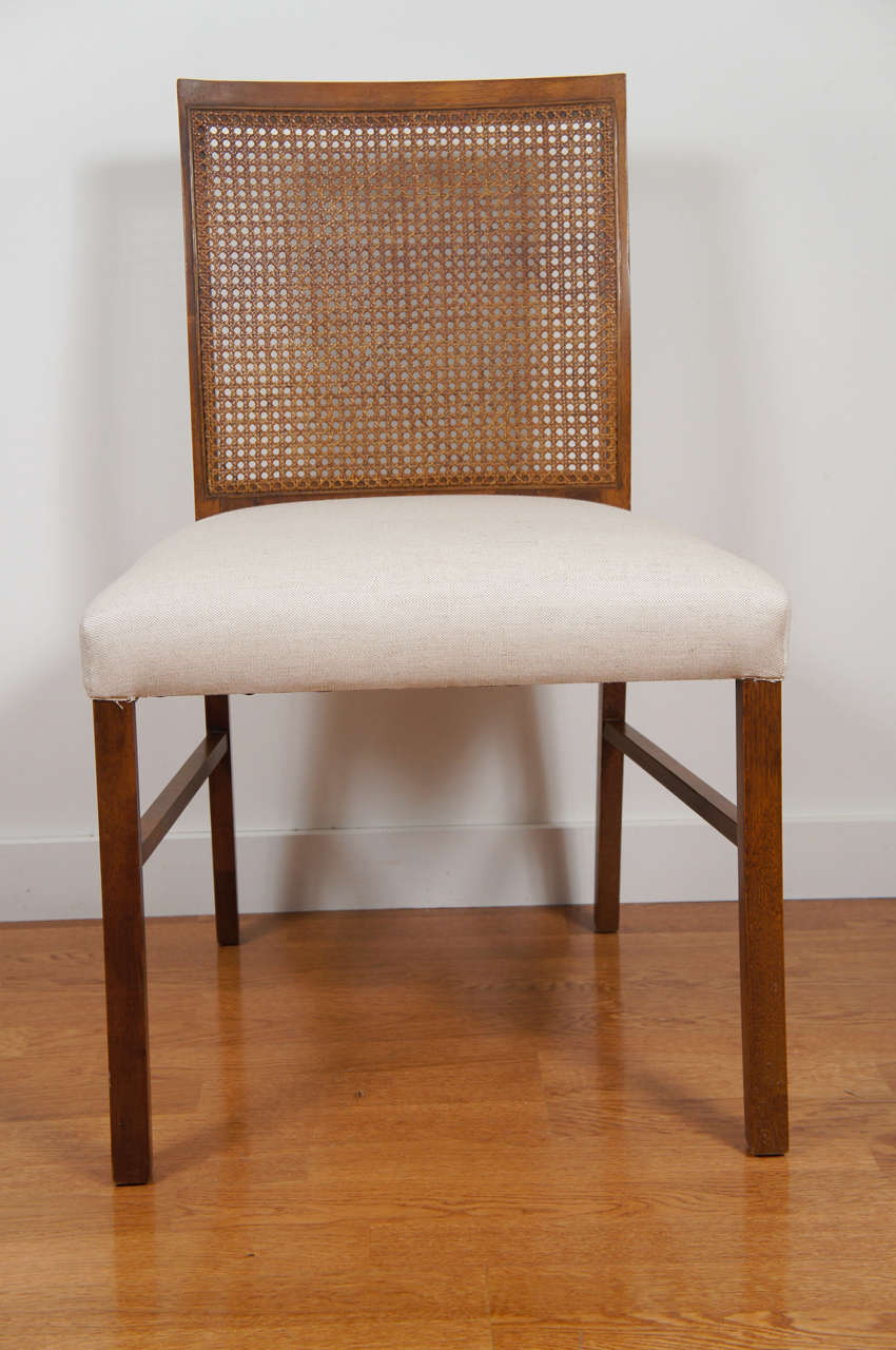 handsome dining chair by Drexel Heritage.
caned back on a walnut frame with newly upholstered, oatmeal, linen fabric seat.