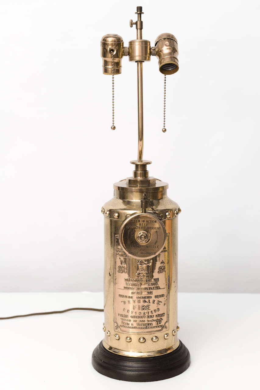 High quality transformation of fire extinguisher into Edwardian look lamp with shade. Beautifully executed with great detail and high polish. There is much text to give interesting detail to lamp. 