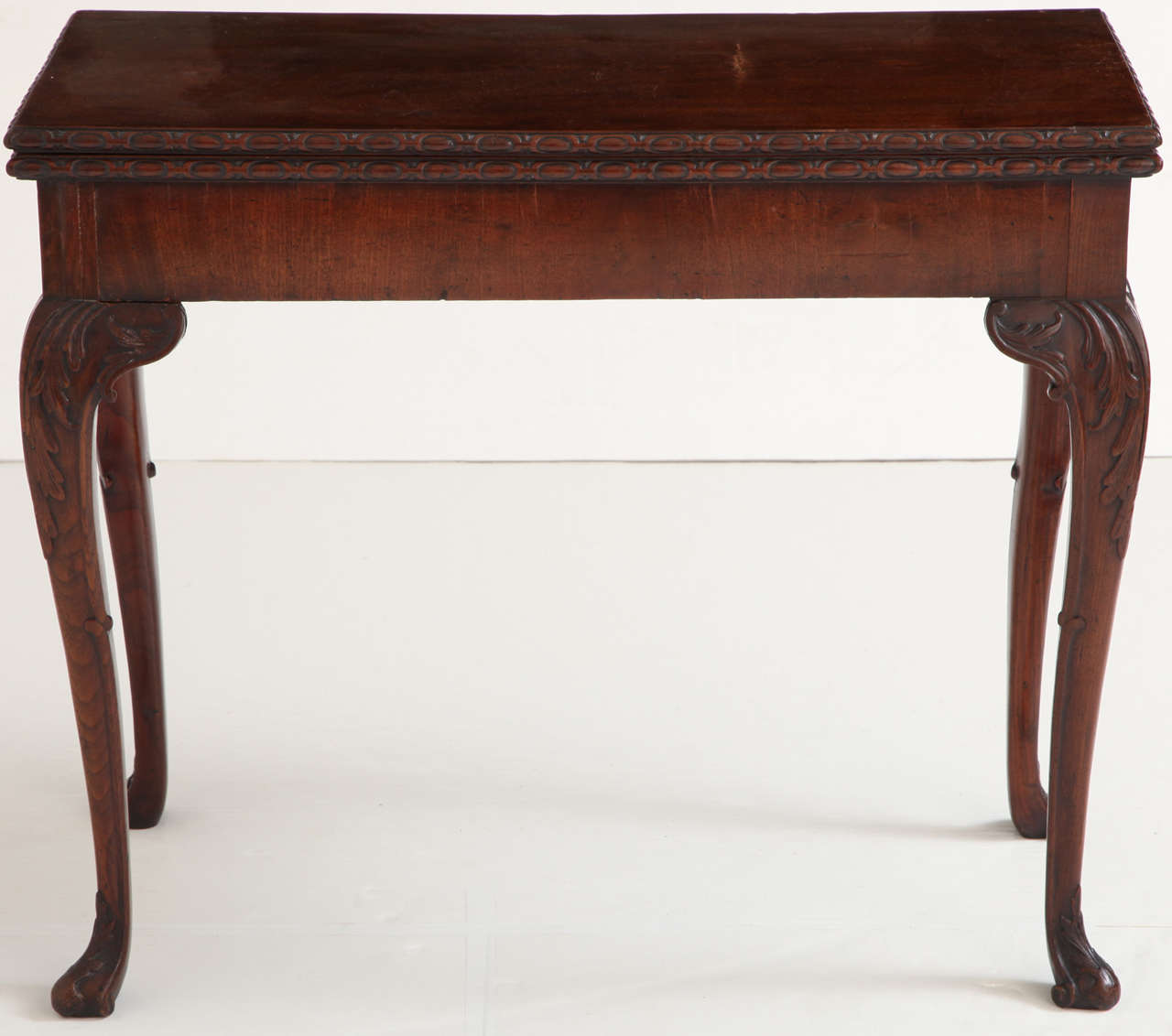 George II mahogany concertina-action games table with egg & dart carved molded edge & raised on cabriole legs.