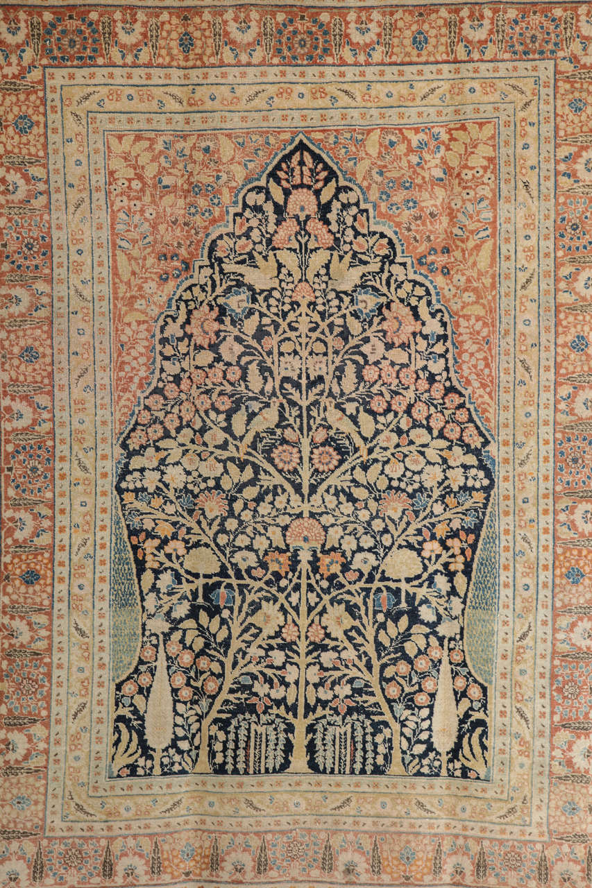This Persian Haji Jalili Tabriz carpet circa 1880 features a tree of life design, hand-knotted handspun wool pile and natural vegetable dyes. Created in the workshop of master weaver Haji Jalili, one of the foremost artists of his time, this carpet