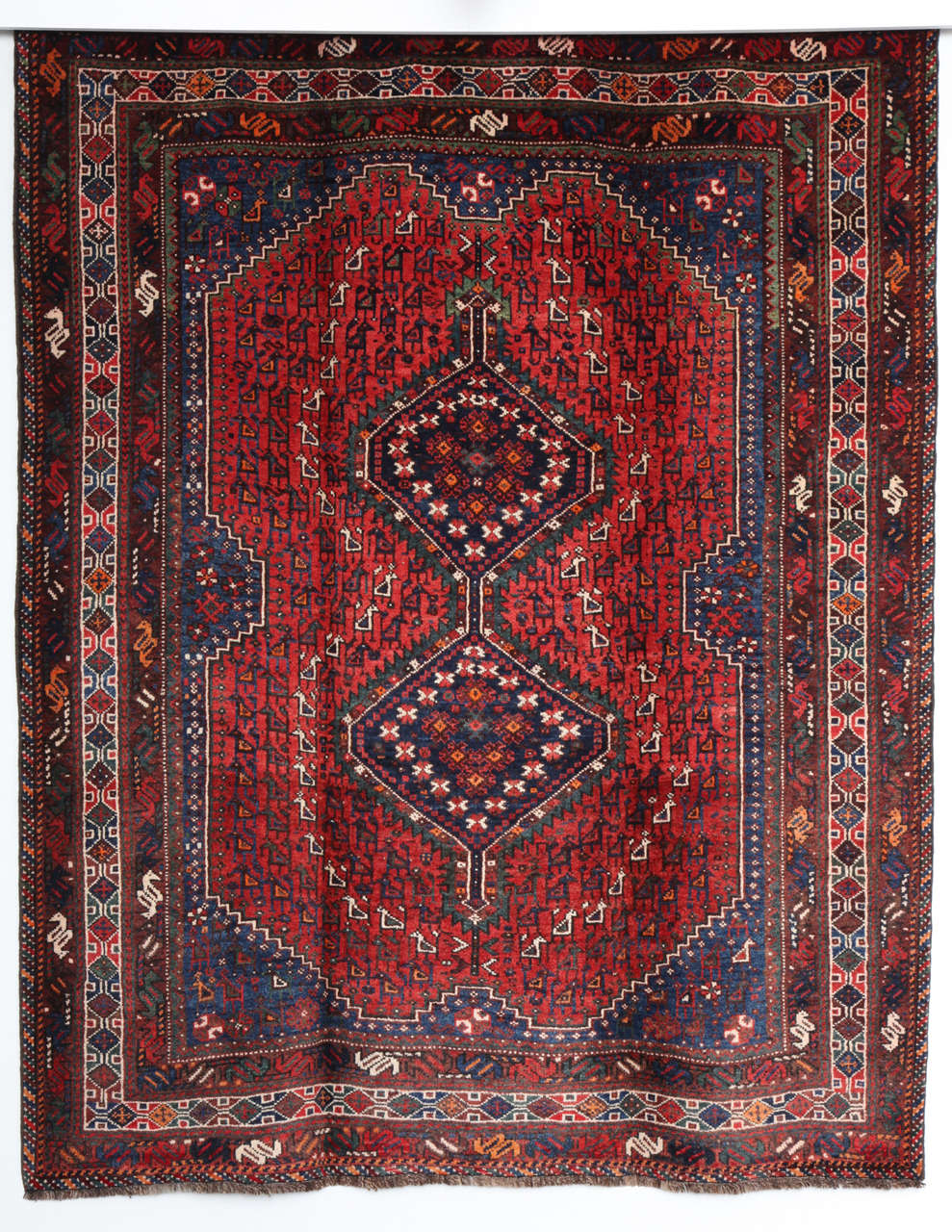 This Persian Qashqai carpet, circa 1920 consists of a pure handspun wool warp, weft and hand-knotted pile and organic vegetable dyes. Its geometric design is exceptionally detailed and balanced in both coloration and proportion. Exhibiting rich