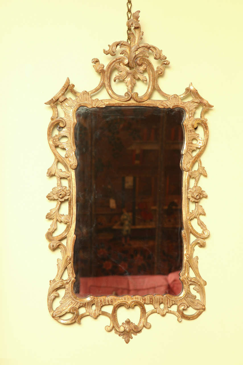 Very fine pair of Chippendale carved and giltwood mirrors, having a central leaf carved cartouche above a pair of facing 