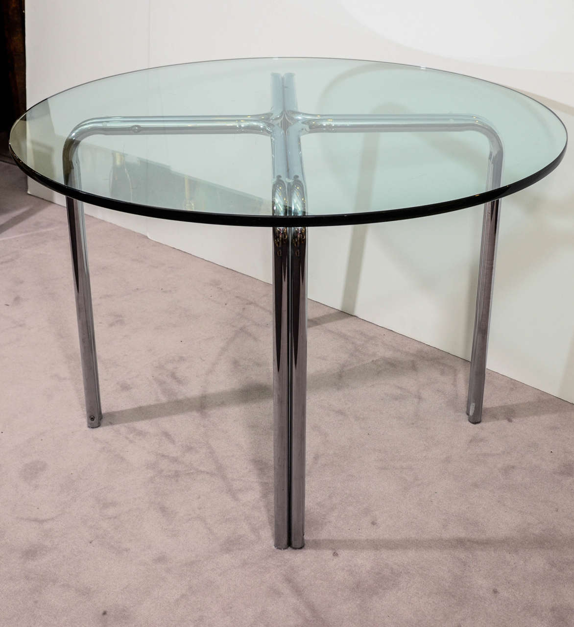 A vintage chrome over tubular steel x-base dining table with a 3/4