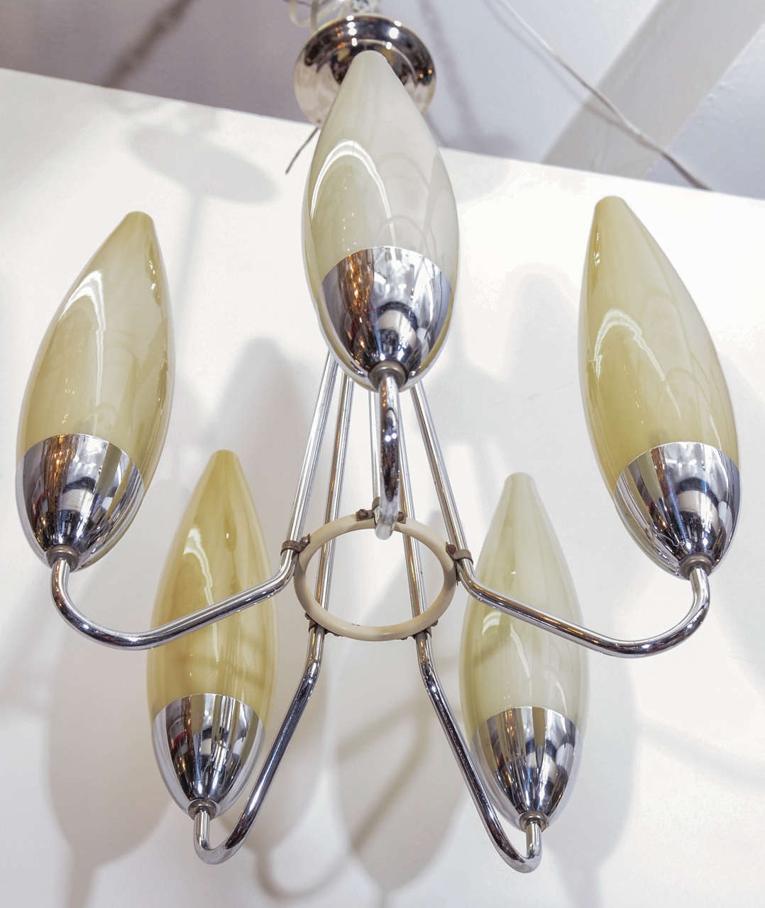 A vintage 1960's Italian five-light chandelier with chrome fixture and off-white glass tubular shades.