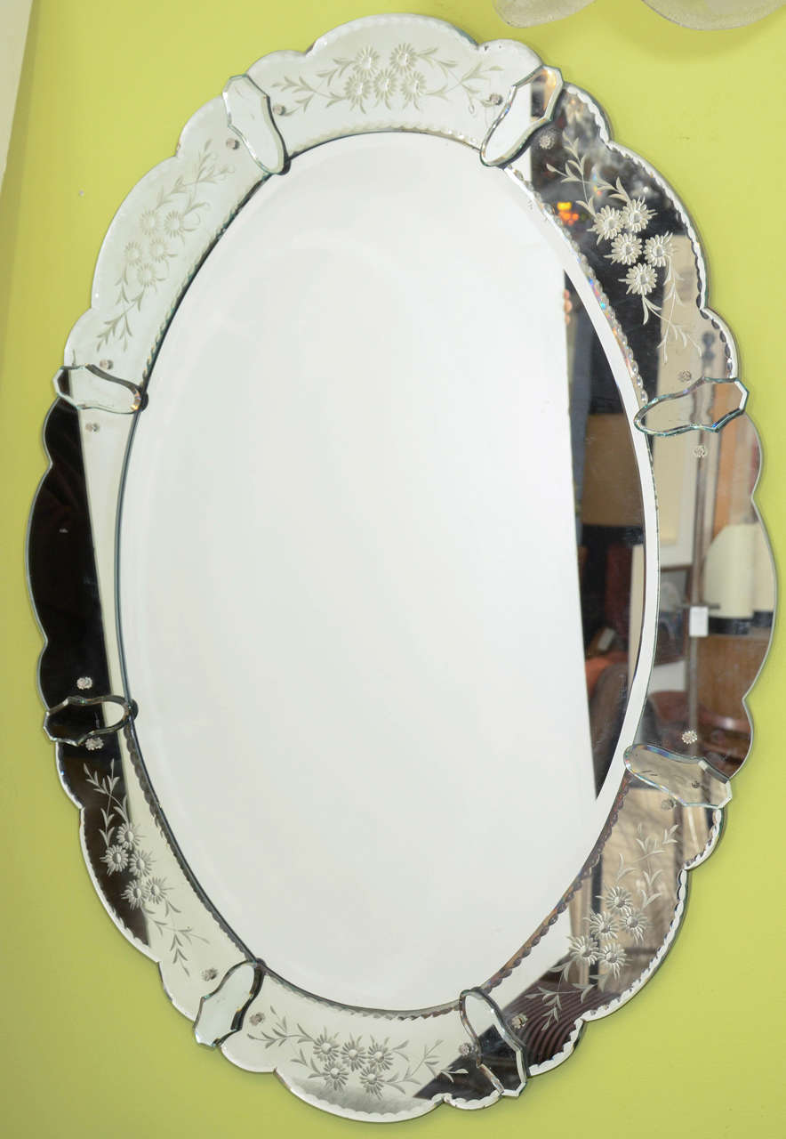 A vintage scalloped edge oval mirror with a mirrored frame etched with a floral pattern. 

Reduced from $975