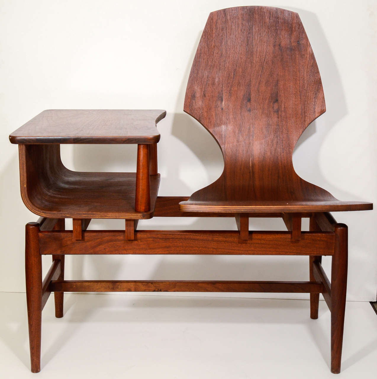 A vintage Danish Modern chair and side table combination in wood.

Please Note: The piece currently available is the opposite configuration from the one pictured; the seat is on the left with the table on the right.