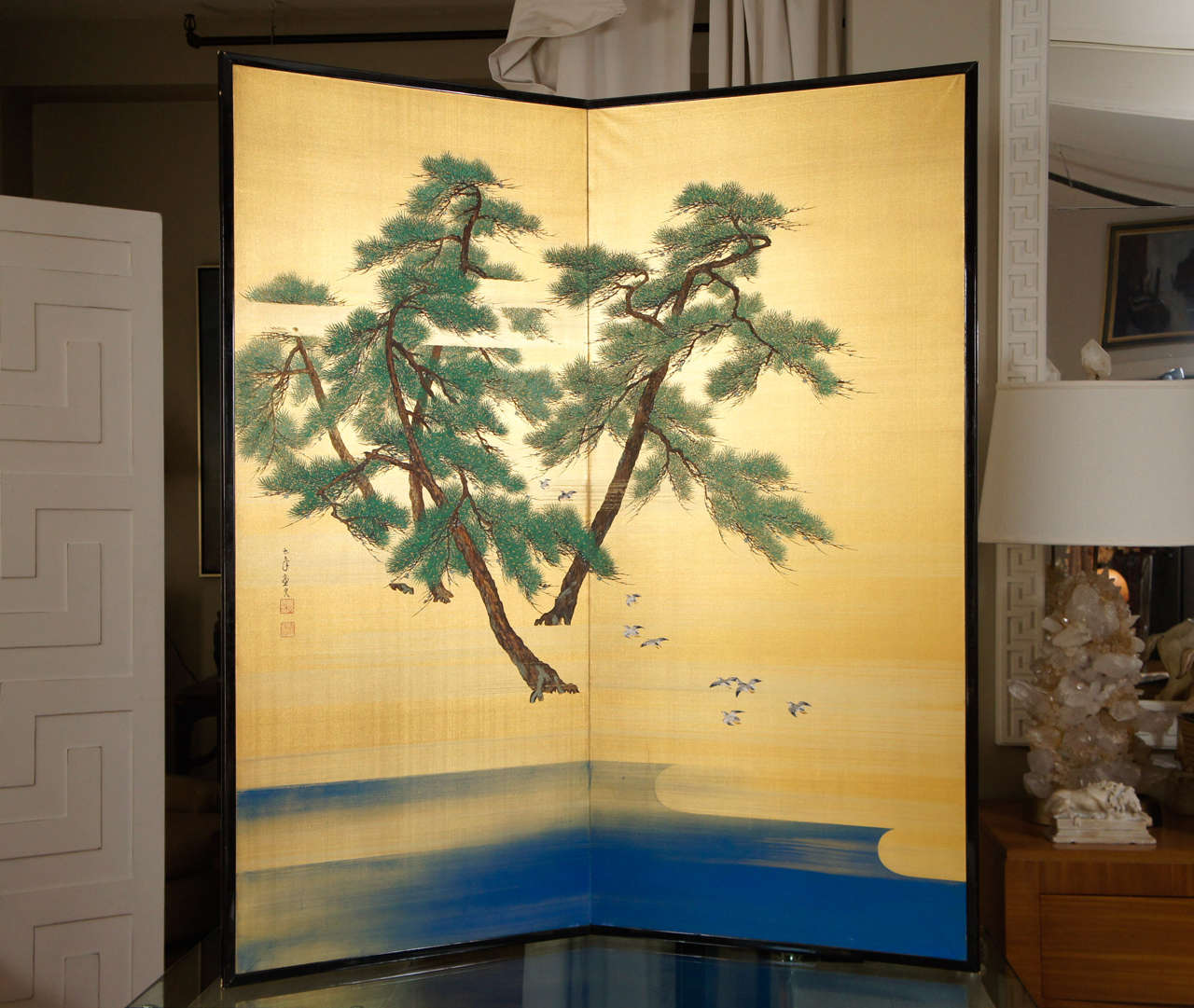 Japanese two panel screen, depicting pine trees and cranes painted on gilded background in a black lacquered frame. Showa period.