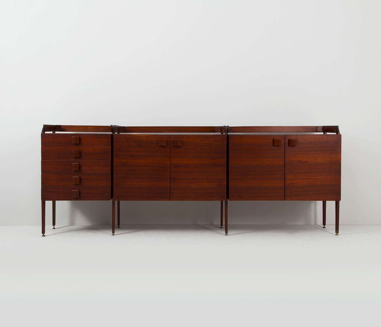 Galleria Mobili d'Arte Cantu, sideboard, Italy, 1960s.

A beautifully designed wall unit, with on the left side six drawers and two storage units in the middle and right side. This unique teak sideboard has an raised edge attached on the buffet with