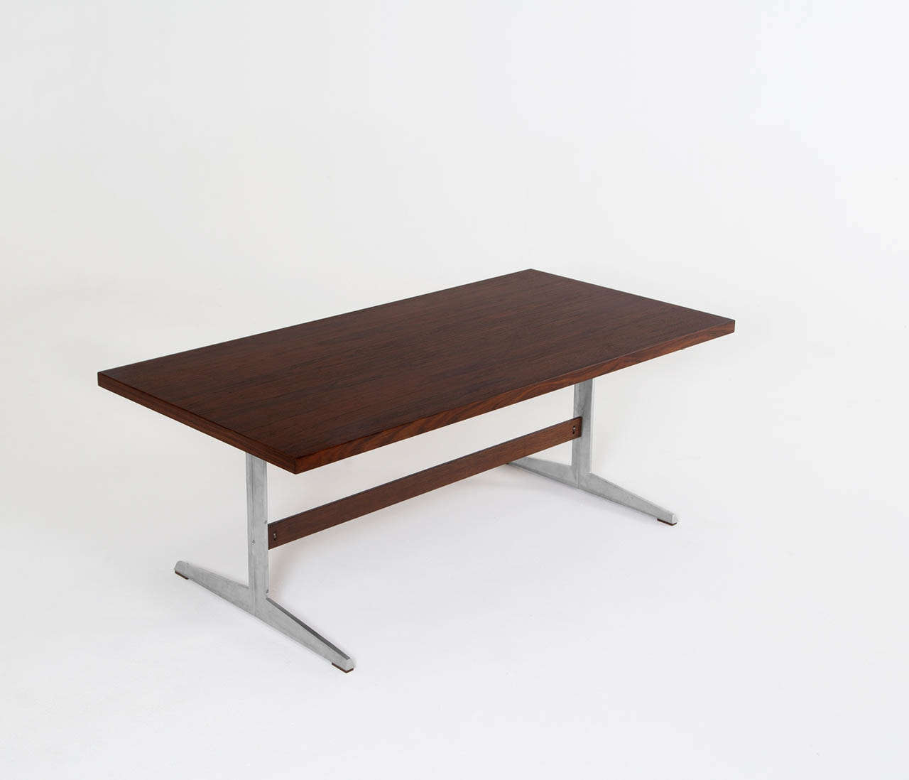 Executive desk, rosewood, aluminum, Denmark, ca. 1960.

This modest table is executed with rosewood and aluminum. The table features simplistic design features. The desk is executed with two trestle feet and a horizontal rosewood beam. The top is